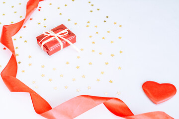 red gift box on a blue background with gold bright confetti. Flat styling style. Holiday concept, space for text