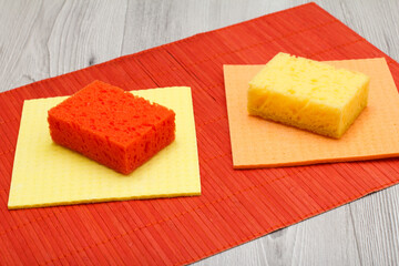 Color synthetic sponges and microfiber napkins for cleaning on bamboo.