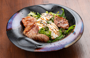 Duck breast salad with cream cheese and arugula. In a decorative plate