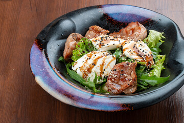 Duck breast salad with cream cheese and arugula. In a decorative plate