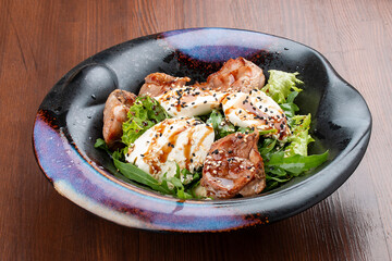 Duck breast salad with cream cheese and arugula. In a decorative plate