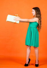 for you. child in summer day on orange background. its shopping time. small girl hold present box. little kid with gift box. happy birthday party. childhood happiness. lets celebrate holiday