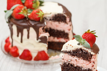 Homemade chocolate cake decorated with fresh strawberries