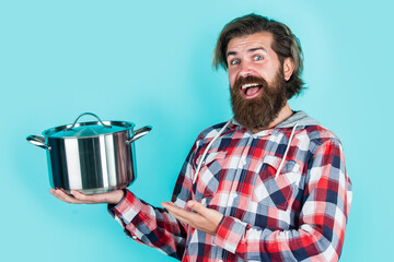 presenting product. Man hold new brand pan. Shopping kitchenware. cooking pot in man hands in kitchen. food preparation and cuisine. cooking utensils vessels. kitchen advertising. Man with saucepan