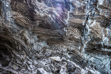 Abstract gray texture of natural, raw salt in an underground salt mine