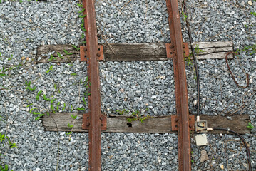 Old and Dangerous Rusty Railway on the Gravel Background
