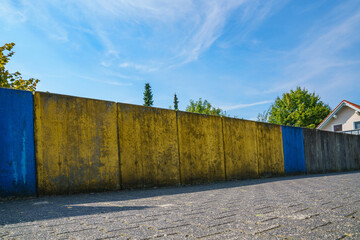 Wooden fence. Painted in yellow-blue color.