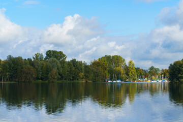Fototapeta premium View from the lake to the forest and the bay for the sailing yachts.