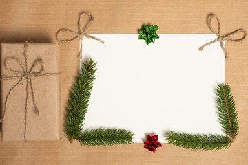 Christmas card with place for text. Gifts, fir tree branches, red decorations. Flat lay, top view, copy space.