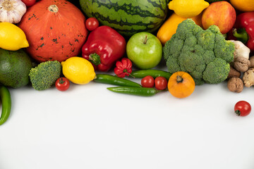 Fitness concept. Healthy nutrition: fruits and vegetables. Equipment for fitness exercises: weighing machine and dumbells. White background.