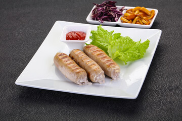 Grilled sausages served mushrooms and cabbage