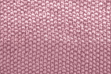 Knitted texture in pink color. Close up.