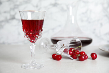 Delicious cherry wine and ripe juicy berries on white table. Space for text