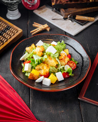 Greek salad with fried fish and cheese