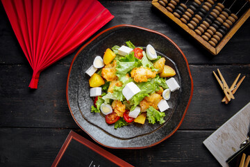 Greek salad with fried fish and cheese