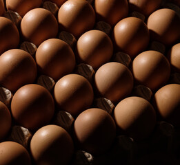 Top view pattern of eggs in a carton tray. Abstract food background.