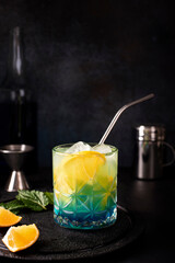 blue curacao cocktail with orange juice and orange slices