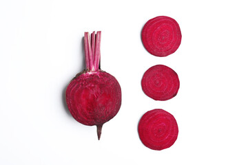 Composition with cut raw beets on white background, top view