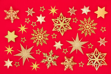 Christmas composition of gold snowflake & star on red background. Abstract design for xmas New Year & holiday season. Flat lay top view.