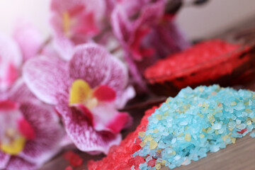 Red and blue sea salt and pink orchid, spa