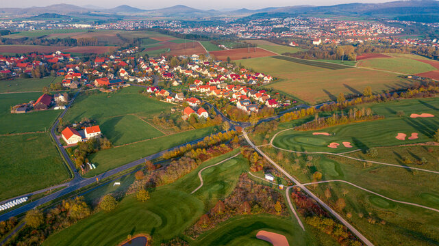 Aerial view of a golf course in autumn with a village, H&uuml;nfeld, Germany.