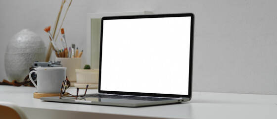 Workspace with laptop, decorations and copy space on white table, include clipping path