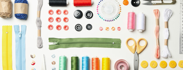 Flat lay with sewing supplies on white background