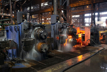 hot steel on conveyor in a steel mill. hot rolled rebar