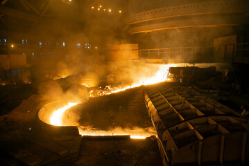 blast furnace iron tapping. Hot steel is poured into another pan
