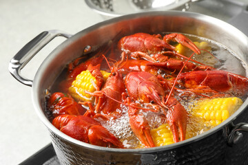Fresh delicious crayfishes in boiling water, closeup