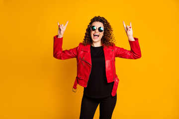 Portrait of her she nice attractive cheerful crazy cool wavy-haired girl showing two horn symbol having fun isolated on bright yellow color background