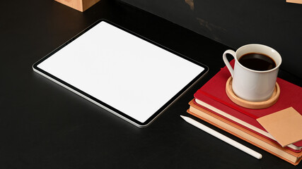 Obraz na płótnie Canvas Workspace with digital tablet, books, stylus and coffee cup in home office, clipping path
