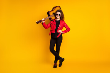 Fototapeta na wymiar Full length body size view of attractive cheerful wavy-haired girl musician carrying bass guitar isolated on bright yellow color background