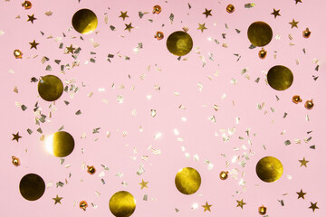 gold shiny flying confetti frame on a pink background