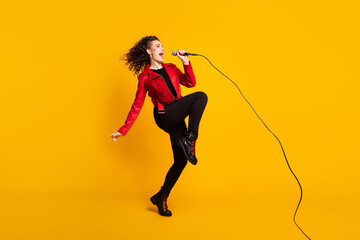 Fototapeta na wymiar Full length body size view of nice cheerful wavy-haired girl vocalist jumping singing hit event isolated on bright yellow color background