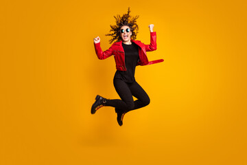 Fototapeta na wymiar Full length body size view of pretty fashionable lucky cheerful wavy-haired girl jumping rejoicing isolated on bright yellow color background