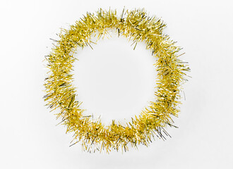 Round circle of yellow, golden tinsel on a white background. Christmas decorations. New year concept