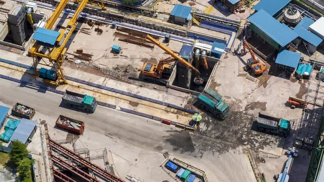 4K Time lapse video of clamshell excavator and dump trucks working at Construction site. (Close up version)