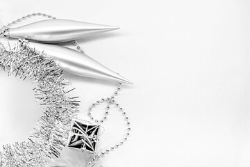Silver long toys, little gift, shiny tinsel. New year decorations on a white background. Christmas...