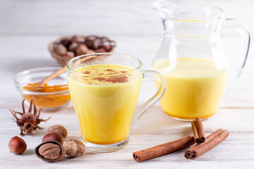 Turmeric Golden Milk or Turmeric Moon Milk in a glass cup on a white background