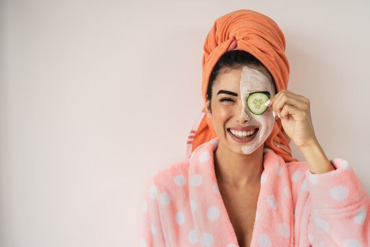Happy smiling girl applying facial organic cream - Healthy beauty treatment and self care lifestyle concept