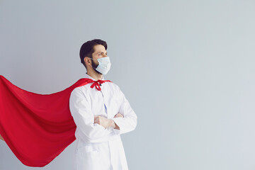 Confident doctor in mask and superhero cape © Studio Romantic