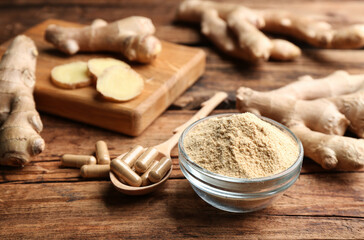 Dry, fresh and capsuled ginger on wooden table