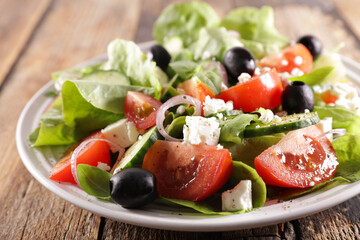 lettuce, tomato, olive and cheese in plate