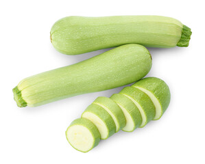 Cut and whole green ripe zucchinis on white background, top view