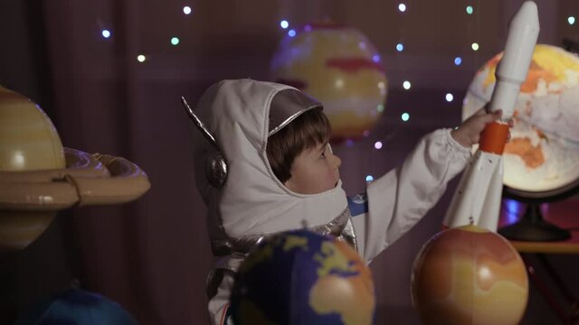 Space Travel Spaceship. Creative Little Kid Boy Astronaut Launching Rocket From Spaceport Through Planets. Child Dreamer Playing Toy Space Rocket Flying Among Planets. Spaceman Fantasy Flying on Space