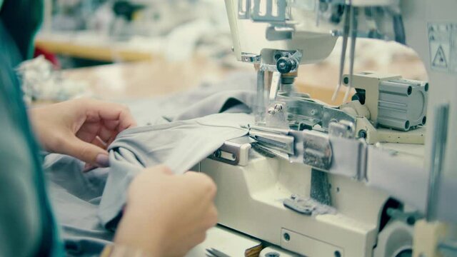Sewing machine is being used to stitch fabric edges
