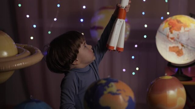 Space Travel Spaceship. Creative Little Kid Boy Astronaut Launching Rocket From Spaceport Through Planets. Child Dreamer Playing Toy Space Rocket Flying Among Planets. Spaceman Fantasy Flying on Space