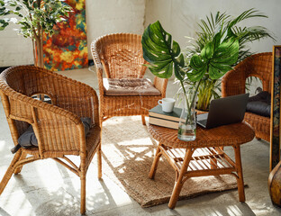 Relaxed and comfortable hotel room for eduaction or working with bamboo furniture and table there are laptop and books with cup.