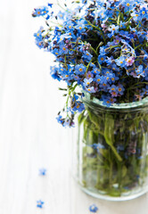 Bouquet of forget-me-not flowers in glass vase